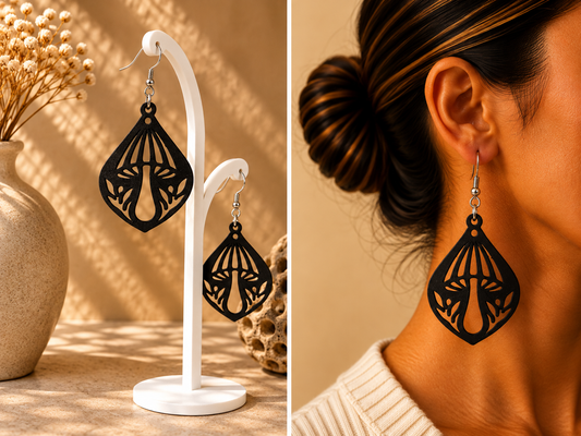 Boucles d’oreilles noires au motif de grand champignon et de feuillage ajourés, présentées sur support et portées